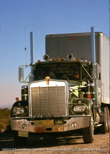 Head on view of Sonny driving the Big Green Kenworth. Will rides shotgun.