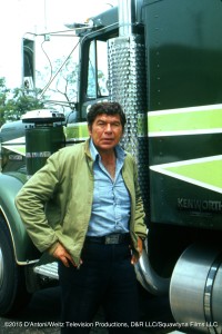 Claude Akins as Sonny Pruitt poses beside the Big Green Kenworth