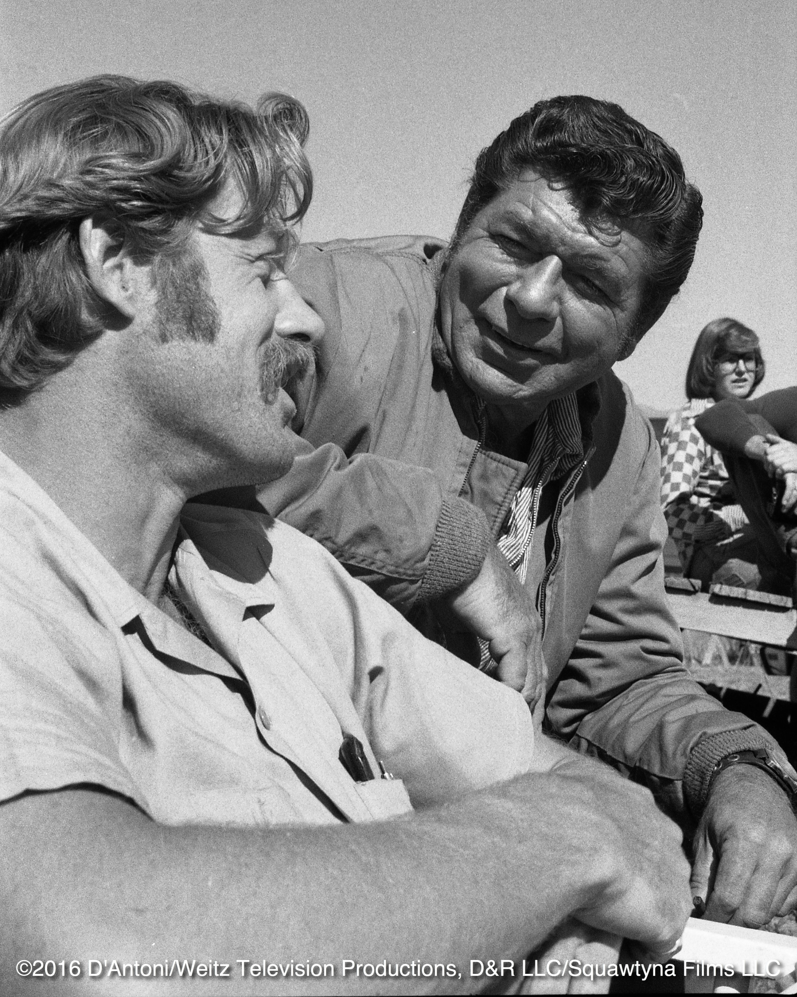 Claude Akins and Frank Converse relaxing on set