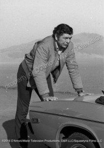 Claude Akins pushes broken down car