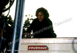 John Rubinstein atop trailer