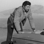 Claude Akins pushes broken down car