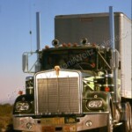 Claude Akins behind the wheel of Sonny Pruitt's Kenworth with Frank Converse beside him