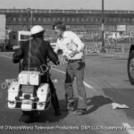 Will Chandler asks a motorcycle cop for help
